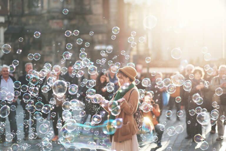 young woman being happy in the middle of bubbles